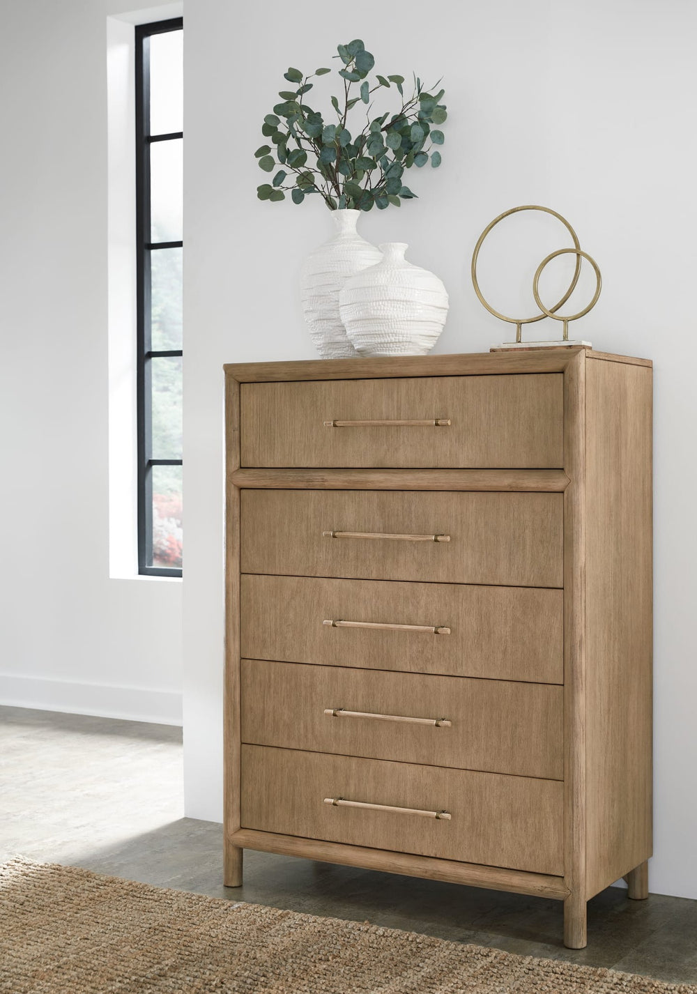 Modus Dorsey five-drawer chest in Granola styled beside a window