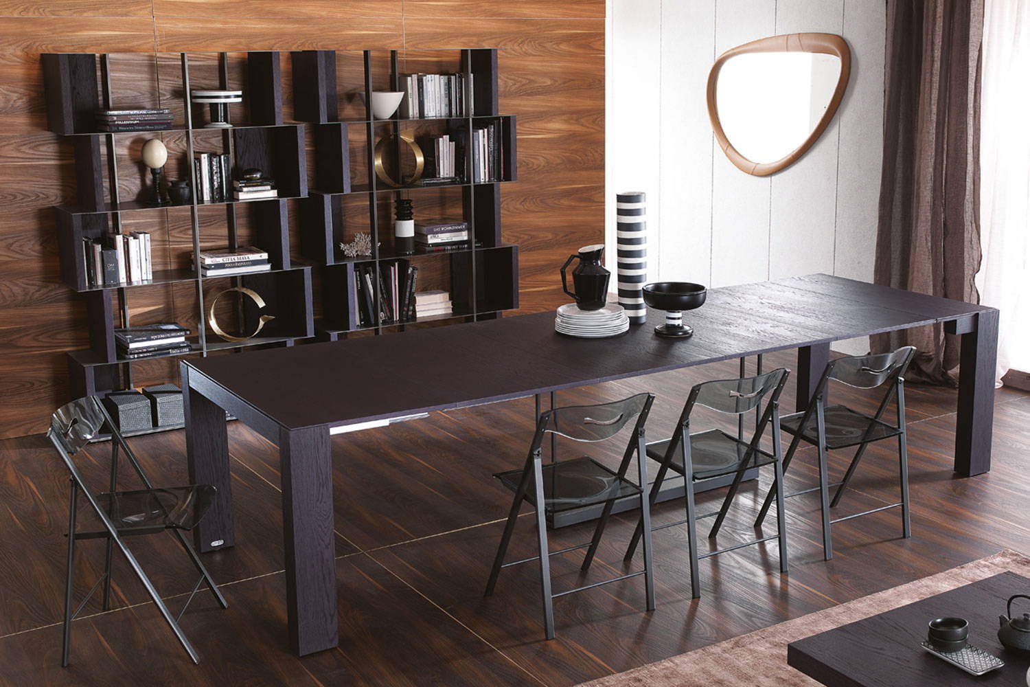 Ozzio Italia A4 extension console table opened for dining with Plio folding chairs, Manga bookcase and Soho mirror
