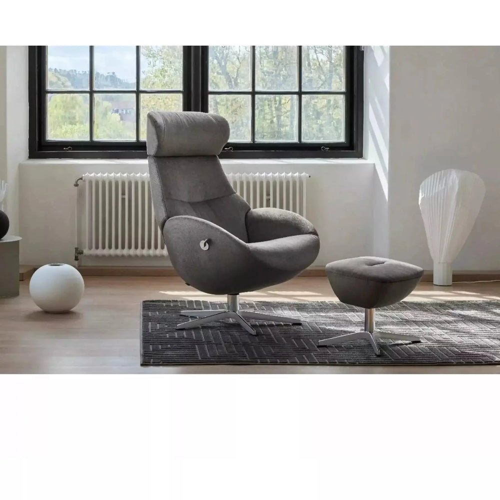 Conform Globe swivel recliner and matching ottoman in dark leather beside a tall window in a bright, white room
