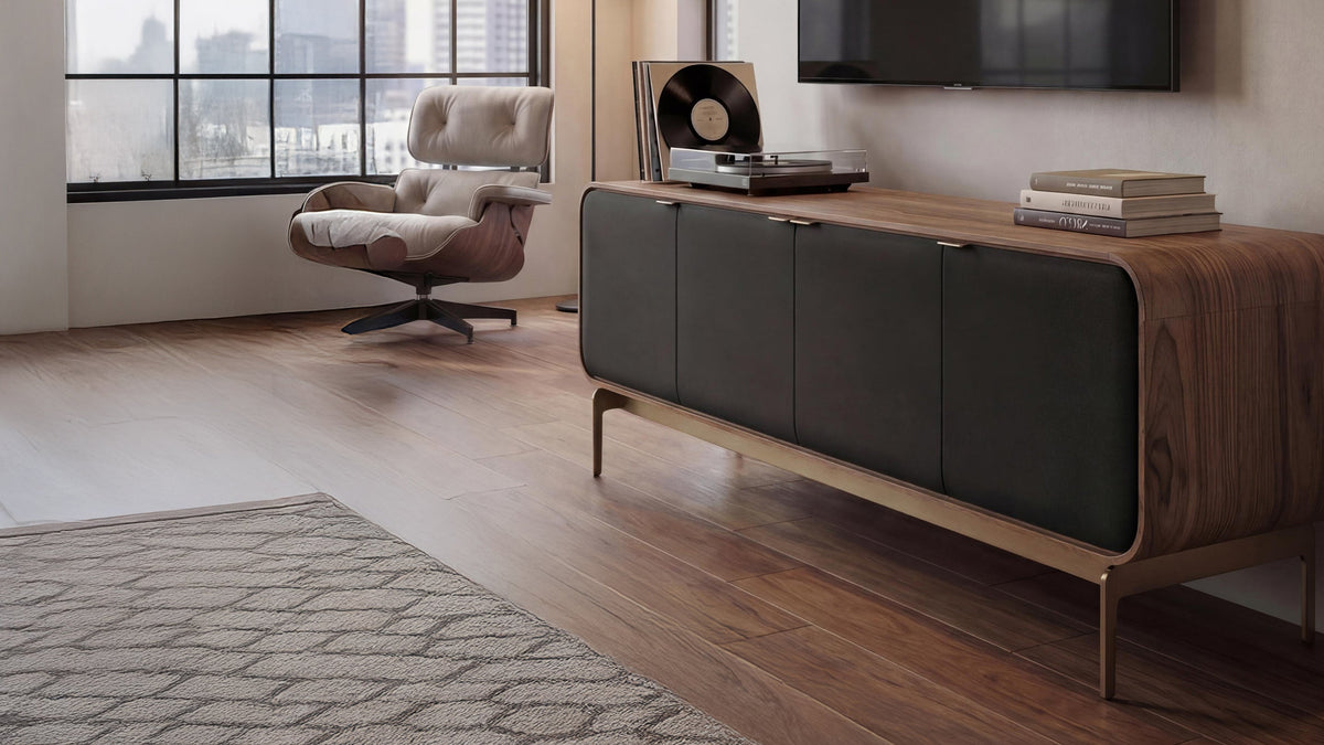 BDI Plume 8079 media console in natural walnut in a sunlit living room with a lounge chair and turntable