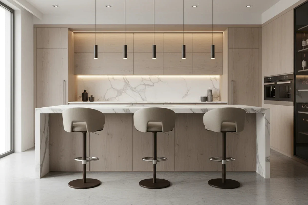 Three Elite Modern upholstered stools with dark pedestal bases at a modern kitchen island