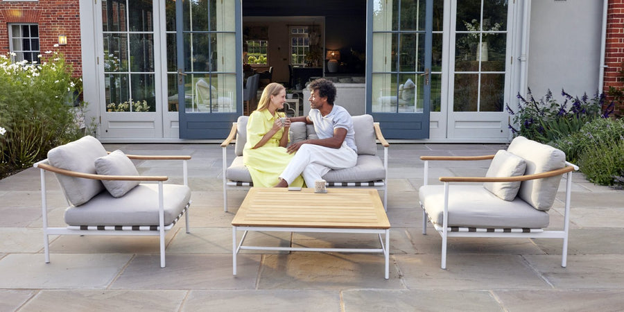 Barlow Tyrie Around deep seating armchairs and sofa on a garden patio