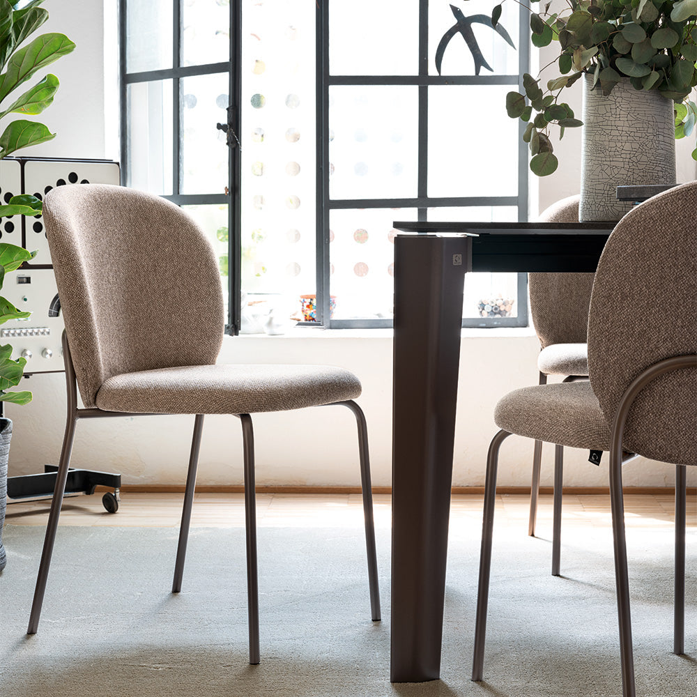 Cozy Mid Dining Chairs in Matte Lava and Cros Taupe at a dining table