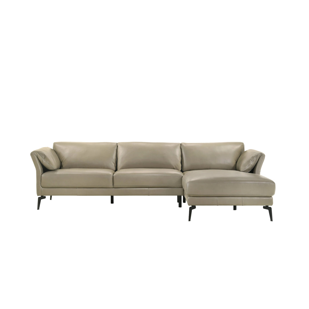 A modern three-seat sofa with a right-side chaise lounge, upholstered in light taupe leather, supported by slim black metal legs, shown against a plain white background.
