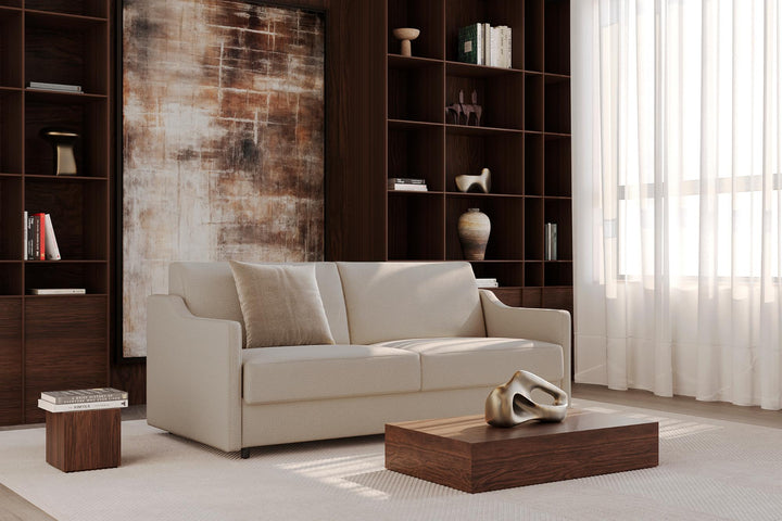 Light beige Carnell sleeper sofa with slope arms in a library-style living room
