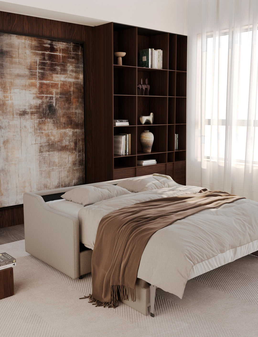 Carnell sleeper sofa opened into a bed with bedding beside tall bookshelves