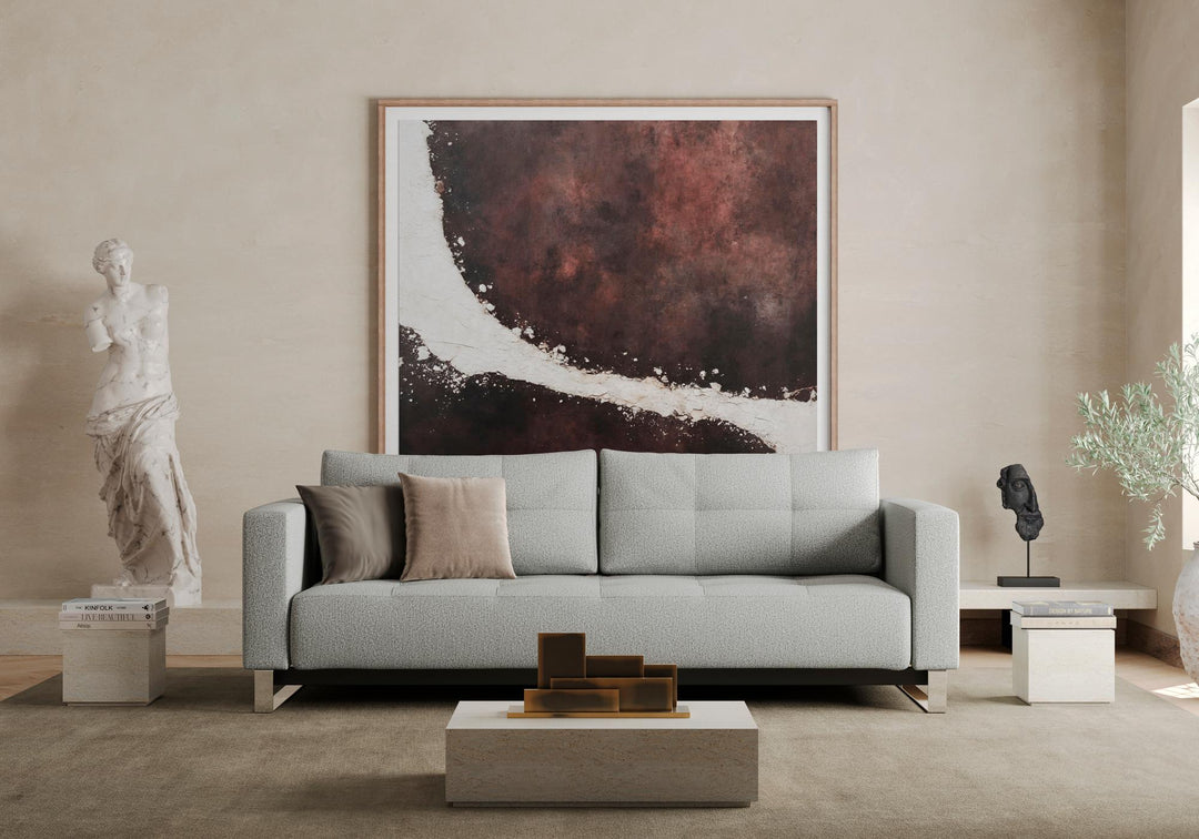 Gray Cassius D.E.L. sleeper sofa in a bright living room with abstract wall art