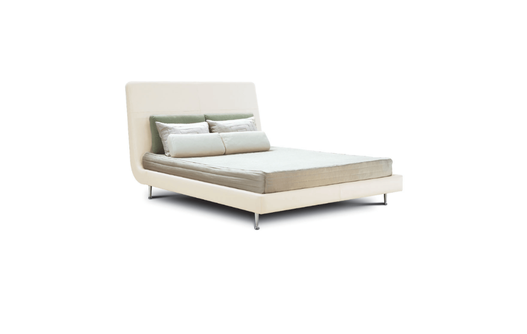 Modern bed with beige bedding and pillows on a white background