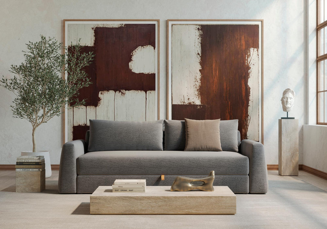 Gray Cone sleeper sofa below large abstract paintings in a bright living room