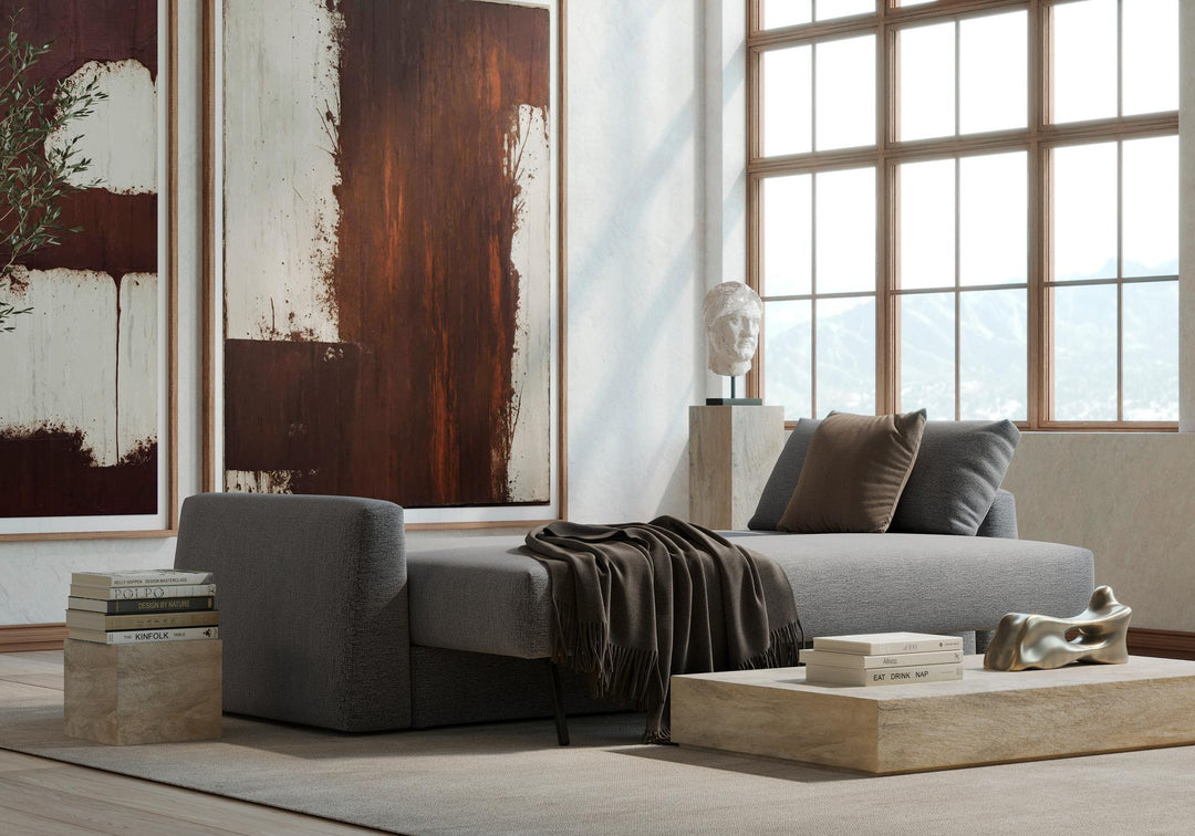 Gray Cone sleeper sofa opened into a bed by tall windows