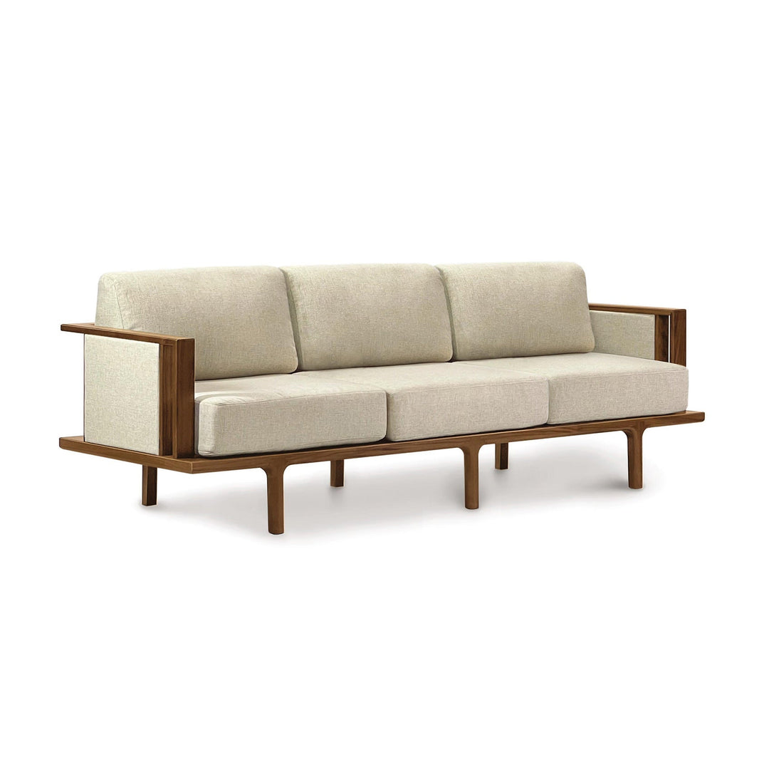 Sierra upholstered-panel sofa in natural walnut