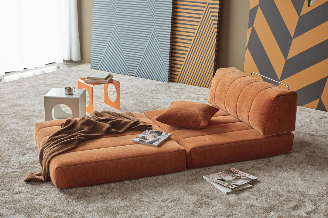 Orange CozyPad chair unfolded into a lounge pad with a throw