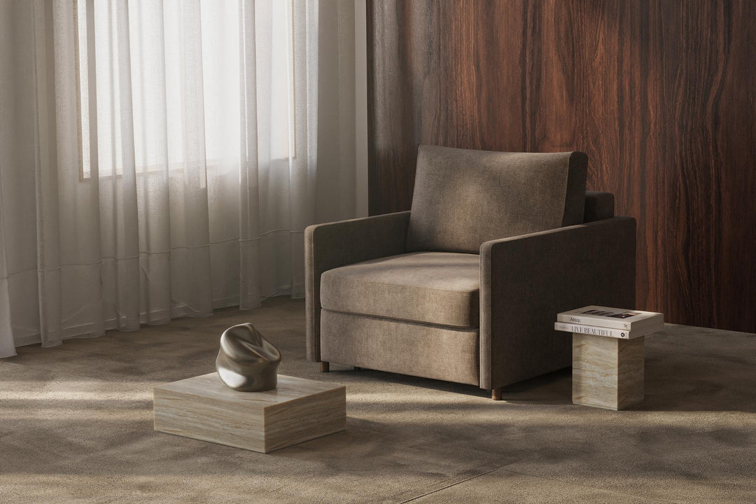 Taupe Neah sleeper chair with slim arms by a window with sheer curtains