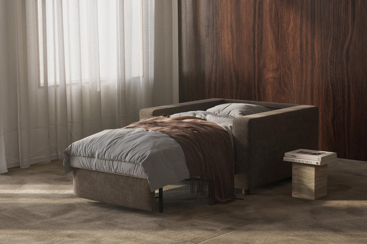 Neah sleeper chair opened into a single bed with gray bedding