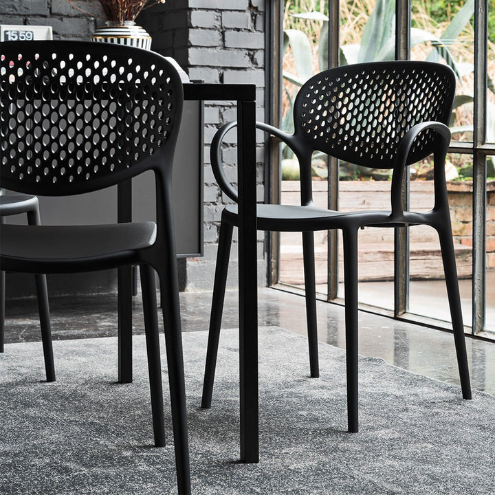 Abby Perforated Dining Armchair by Connubia in a styled interior