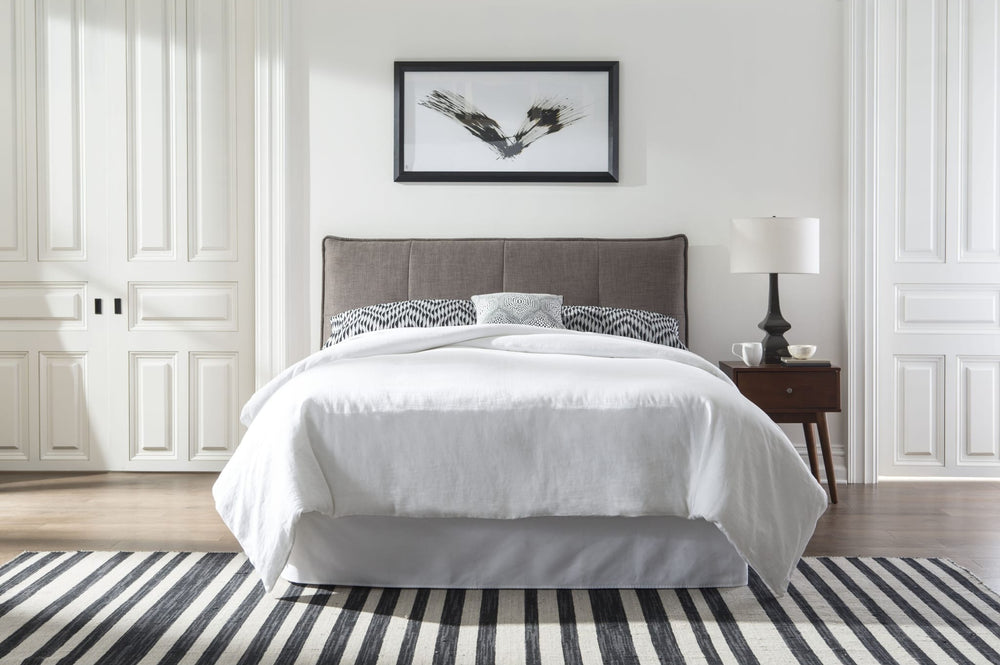 Adona Upholstered Platform Bed in Dolphin Linen styled in a bedroom