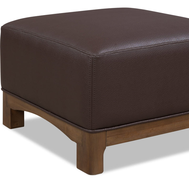 Arden Upholstered Ottoman in Tavern Brown — on a white background