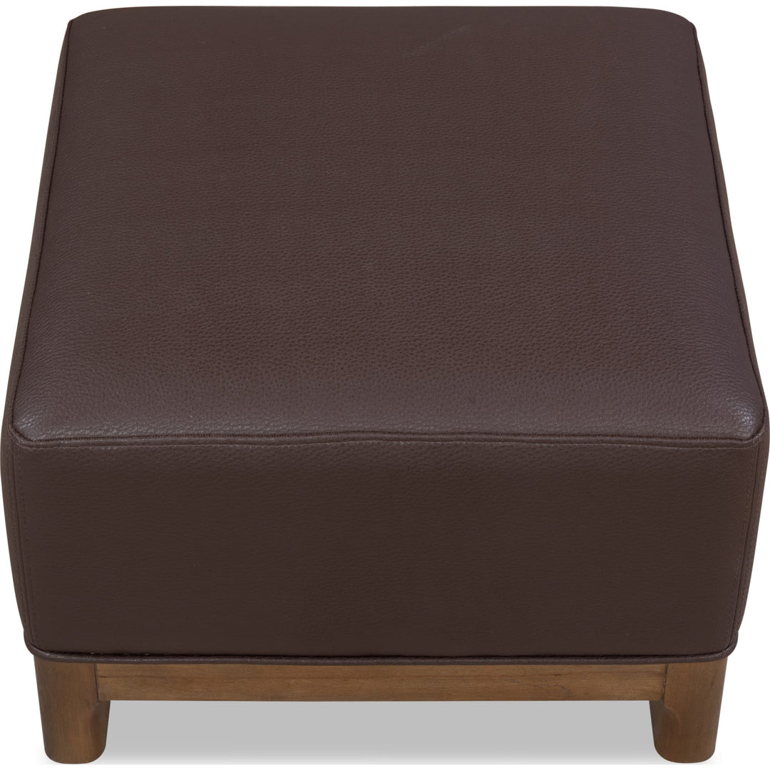 Arden Upholstered Ottoman in Tavern Brown — on a white background