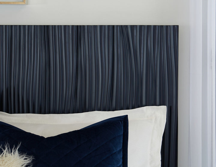 Argento Wave-Patterned Bed in Navy Blue &amp; Burnished Brass — close-up of the wave-patterned headboard