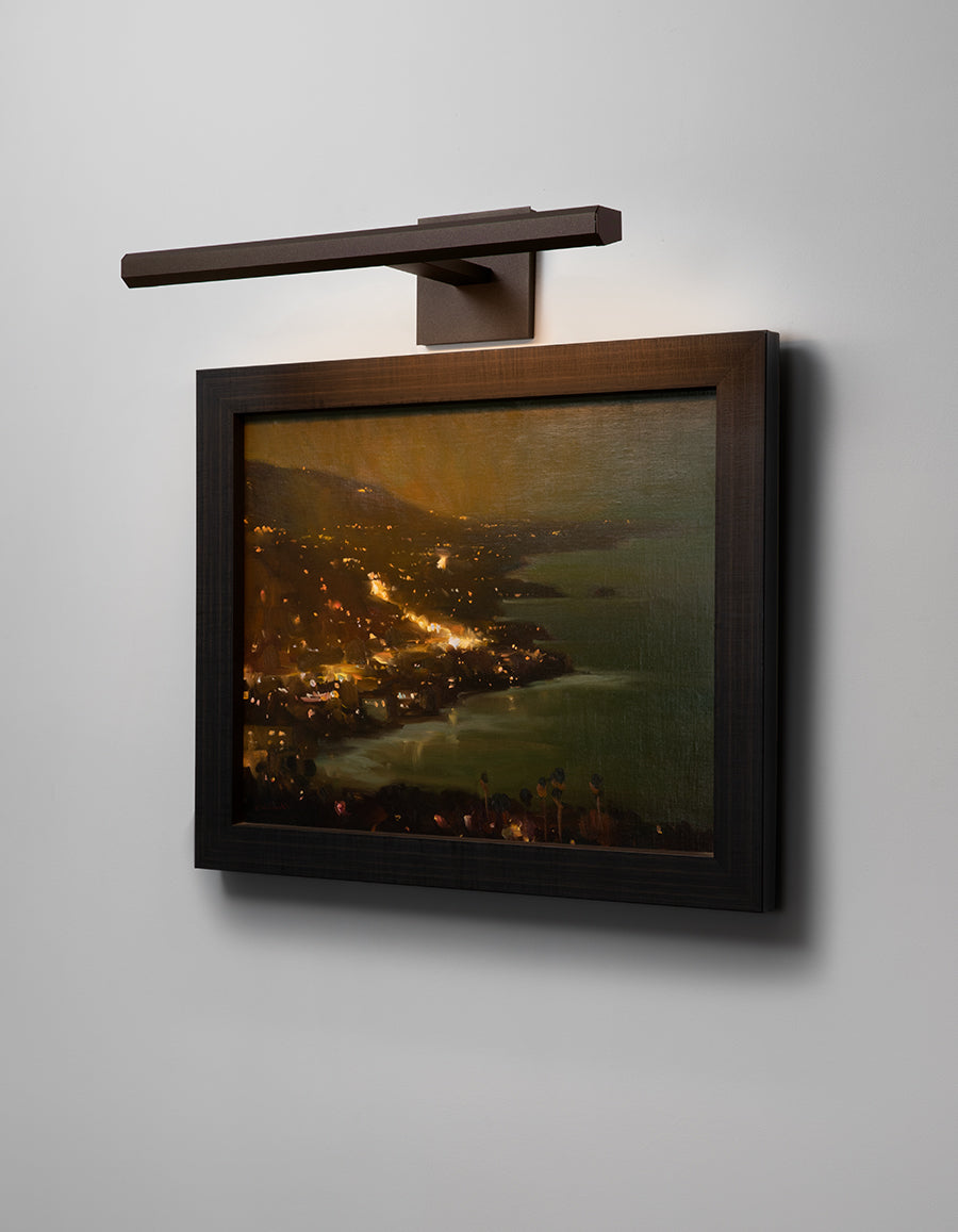 Cerno Art Light illuminating artwork in an interior at night