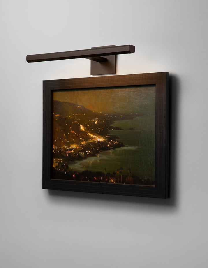 Cerno Art Light illuminating artwork in an interior at night