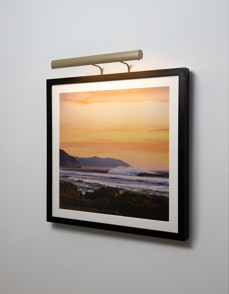Cerno Art Light illuminating artwork in a warm modern interior