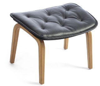 Conform Bravo footstool with a black tufted cushion and four curved natural wood legs