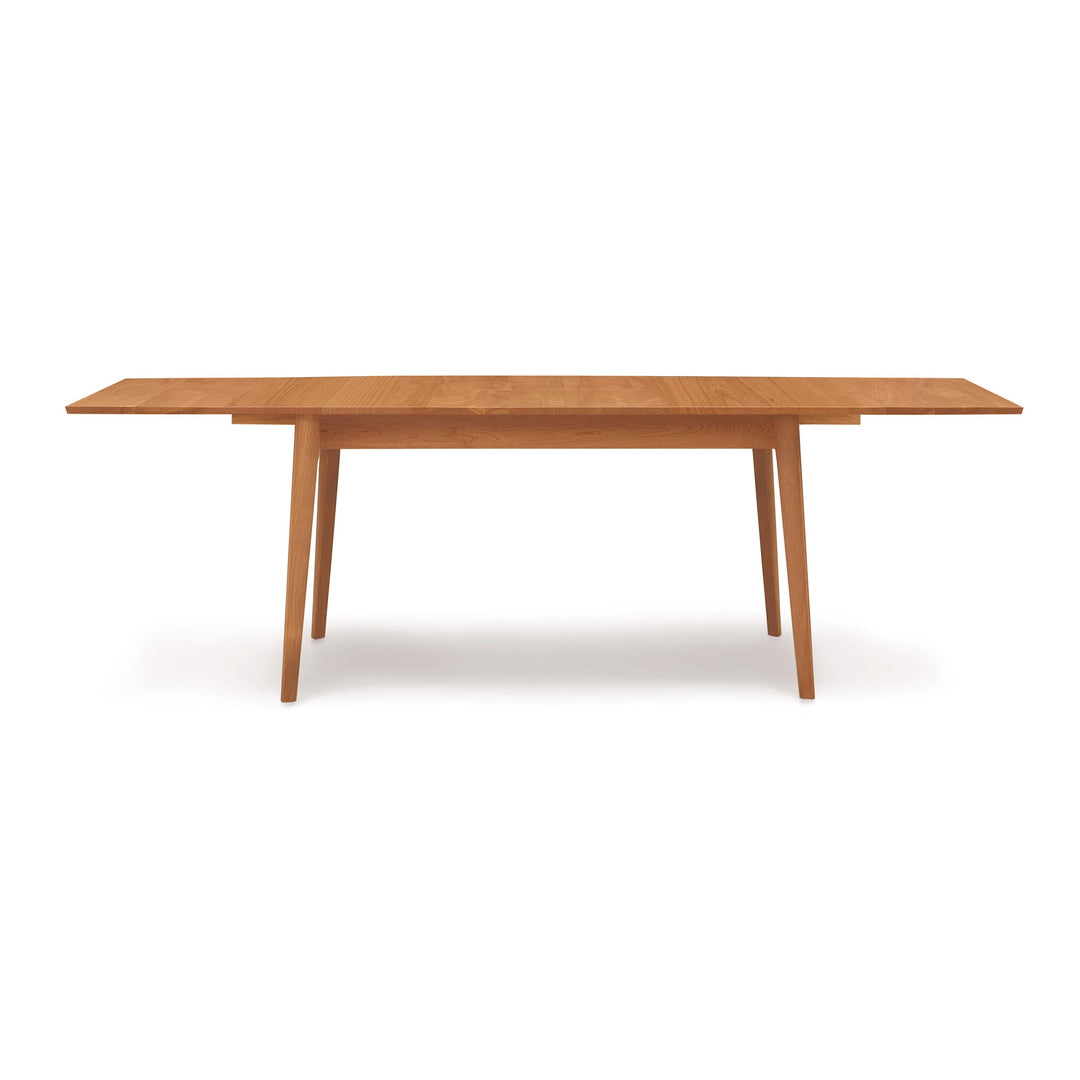 Catalina Four Leg Extension Table shown extended with its self-storing leaf