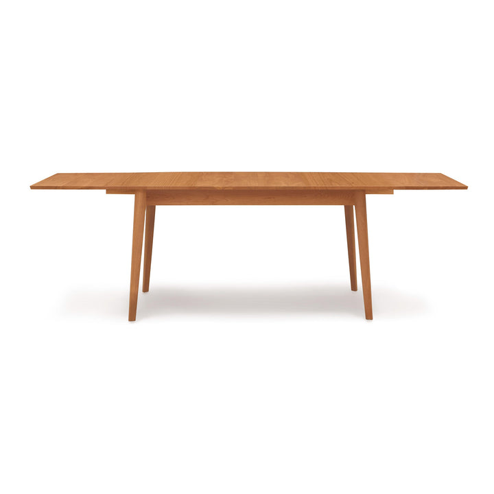 Catalina Four Leg Extension Table shown extended with its self-storing leaf