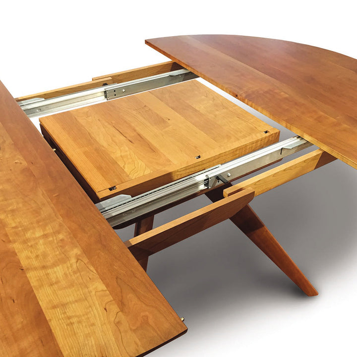 Catalina Round Extension Table shown extended with its butterfly leaf