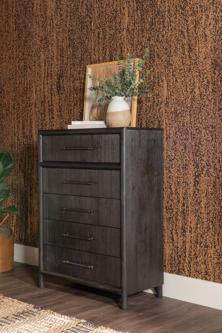 Dorsey Five Drawer Chest in Basalt Grey styled against a textured wall