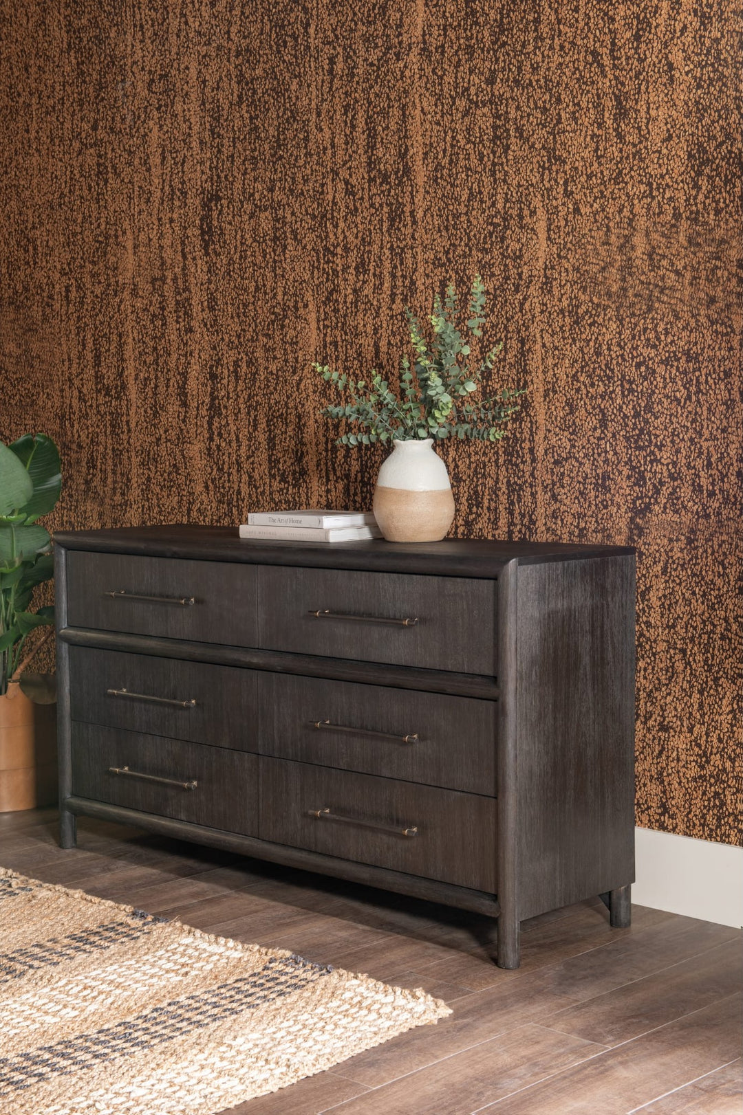 Dorsey Six Drawer Dresser in Basalt Grey styled against a textured wall