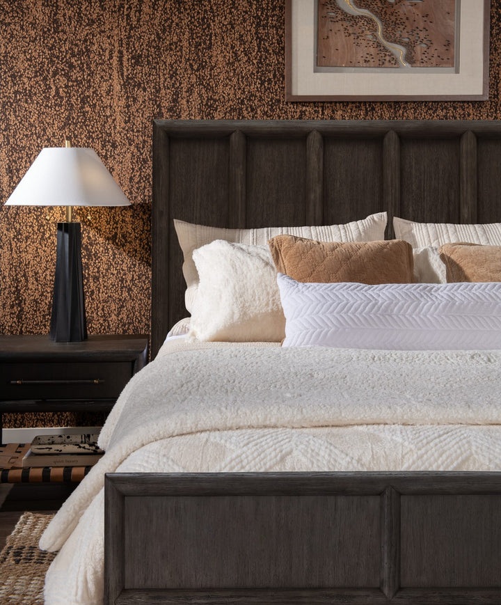 Dorsey Wooden Panel Bed in Basalt Grey — close-up with bedding and nightstand lamp