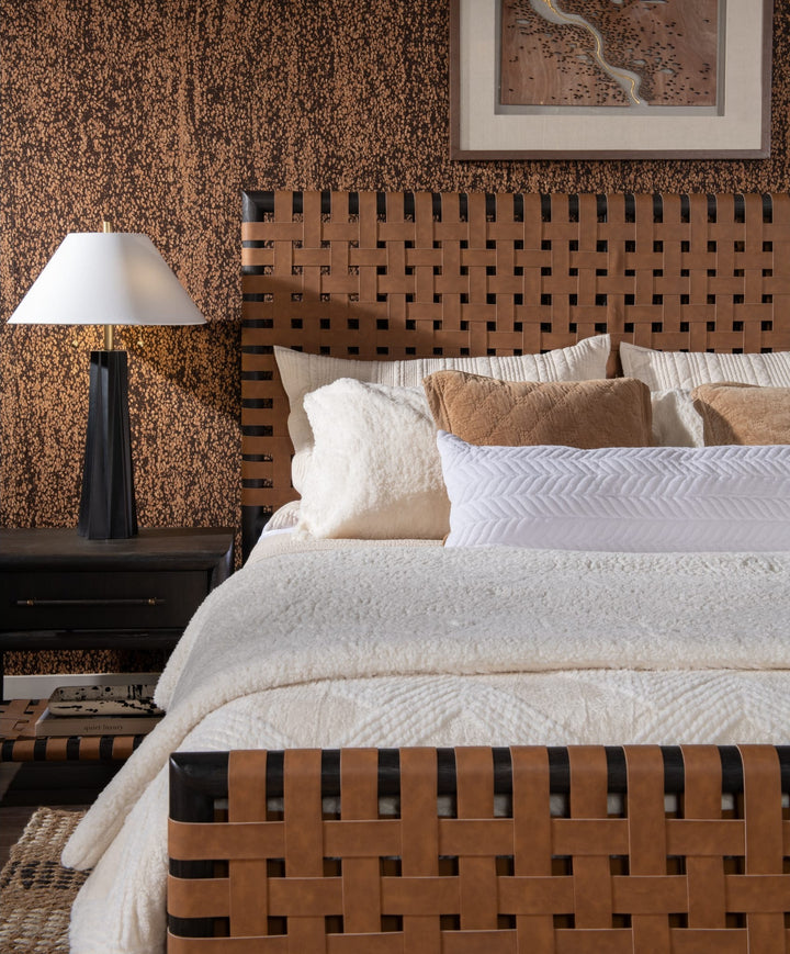 Dorsey Woven Panel Bed in Basalt Grey and Ginger — close-up with bedding and nightstand lamp
