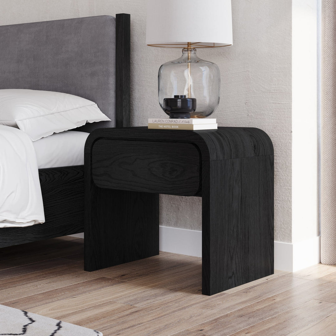 Elora One Drawer Nightstand in Jet — in a bedroom setting
