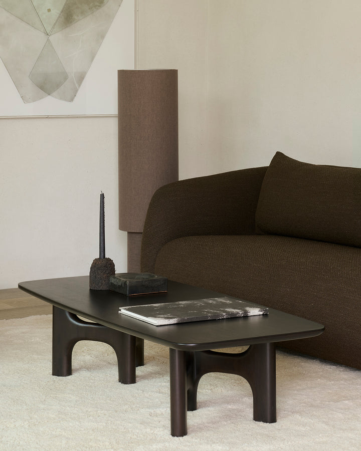 Ethnicraft Flow rose brown coffee table in a contemporary living room
