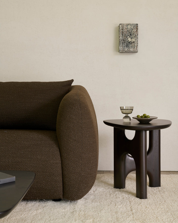Ethnicraft Flow side table beside a Figur sofa in a modern living room