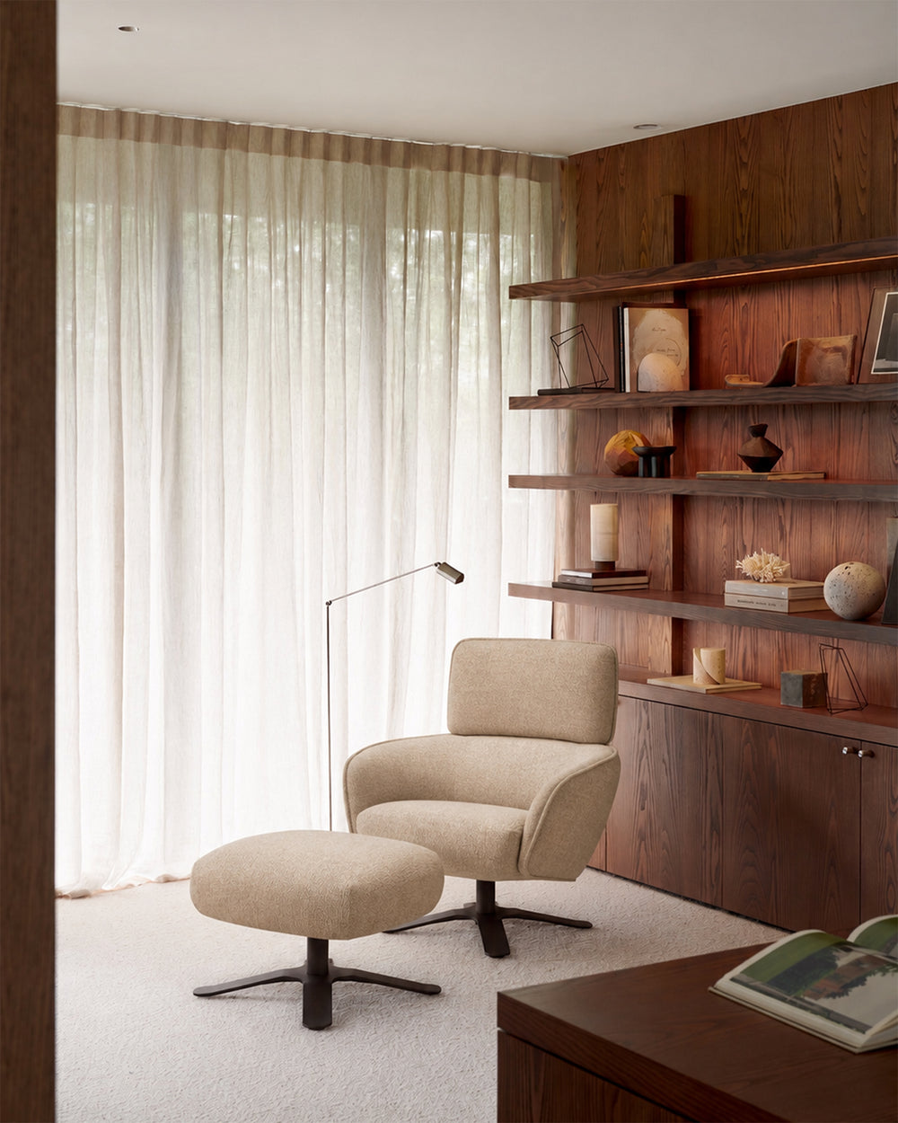 Merge footstool by Ethnicraft beside the matching lounge chair in a living room; chair sold separately