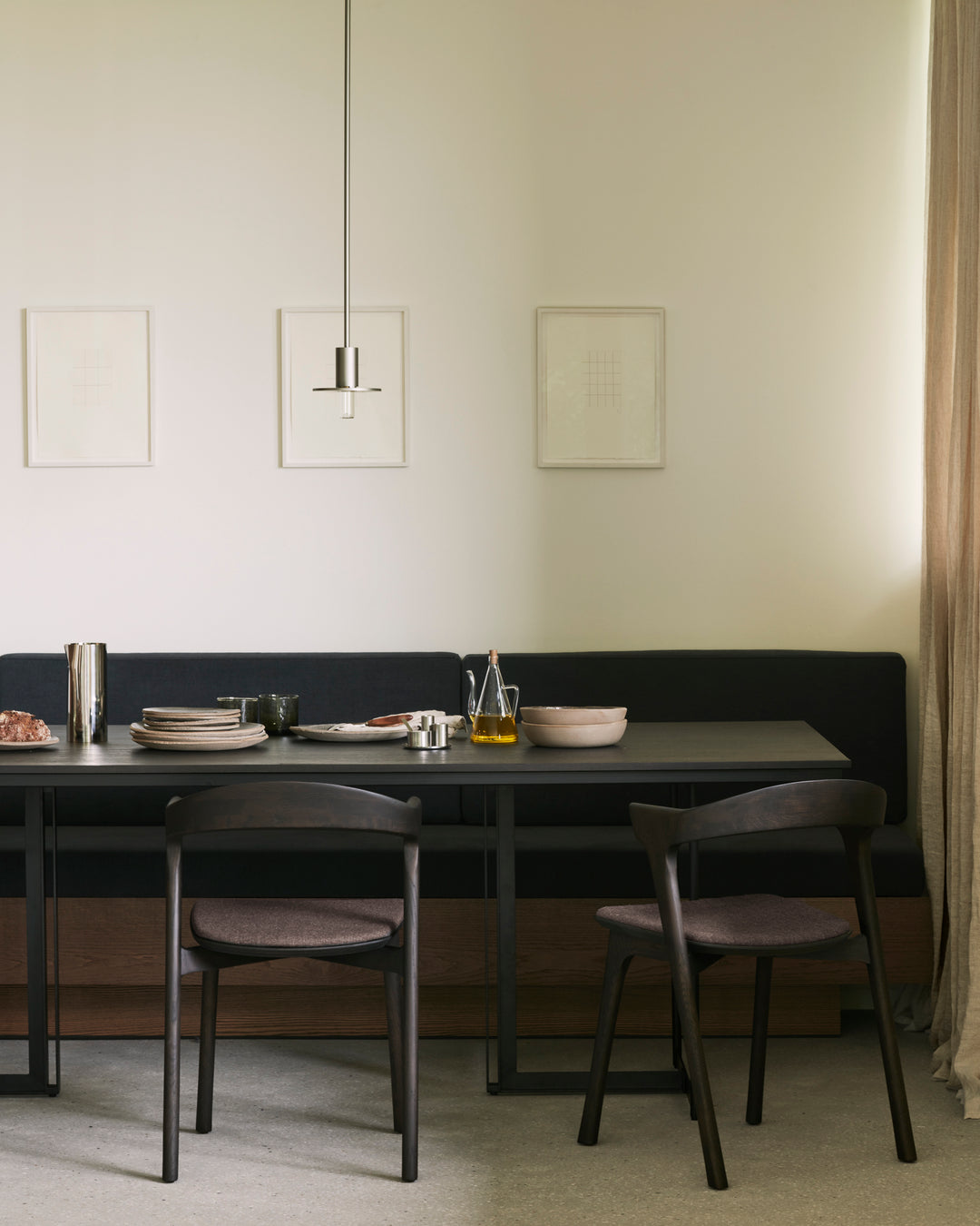 Ethnicraft Tacet dining table styled in a modern dining interior