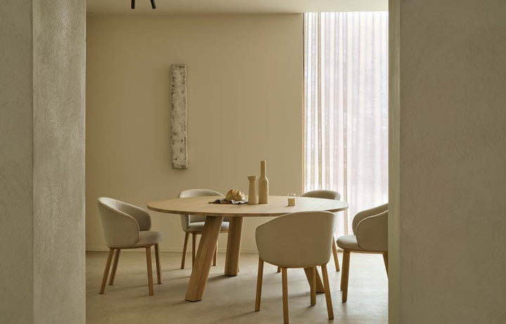Ethnicraft Unda oak dining table in a warm modern dining room