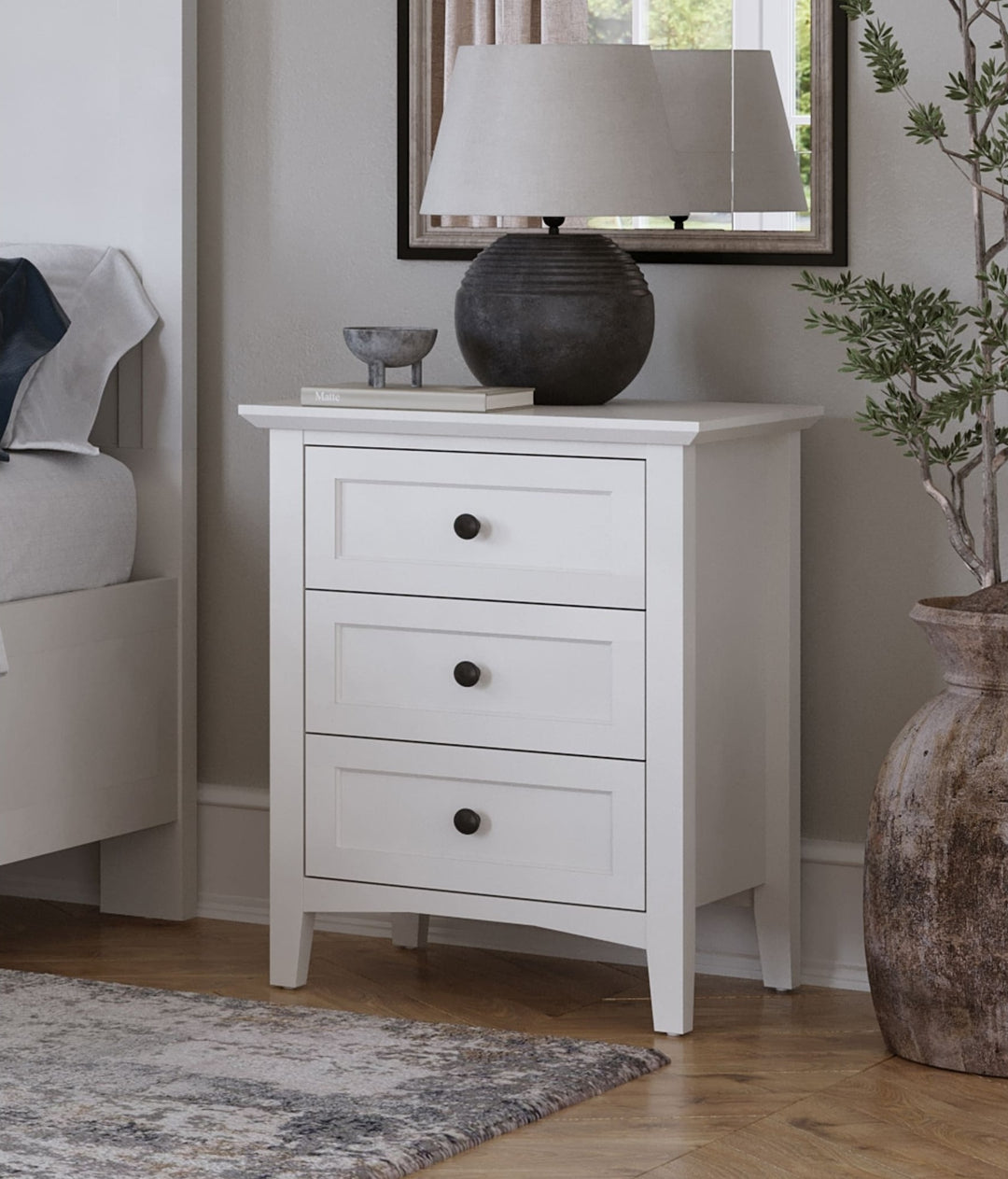 Grace Three Drawer Nightstand in Snowfall White — in a bedroom setting