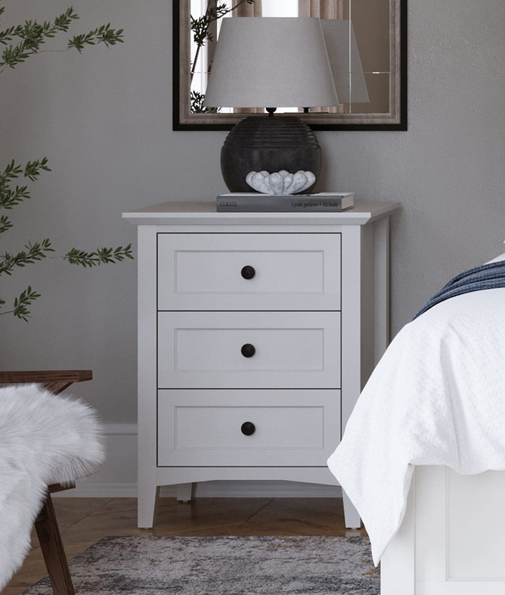 Grace Three Drawer Nightstand in Snowfall White — in a bedroom setting