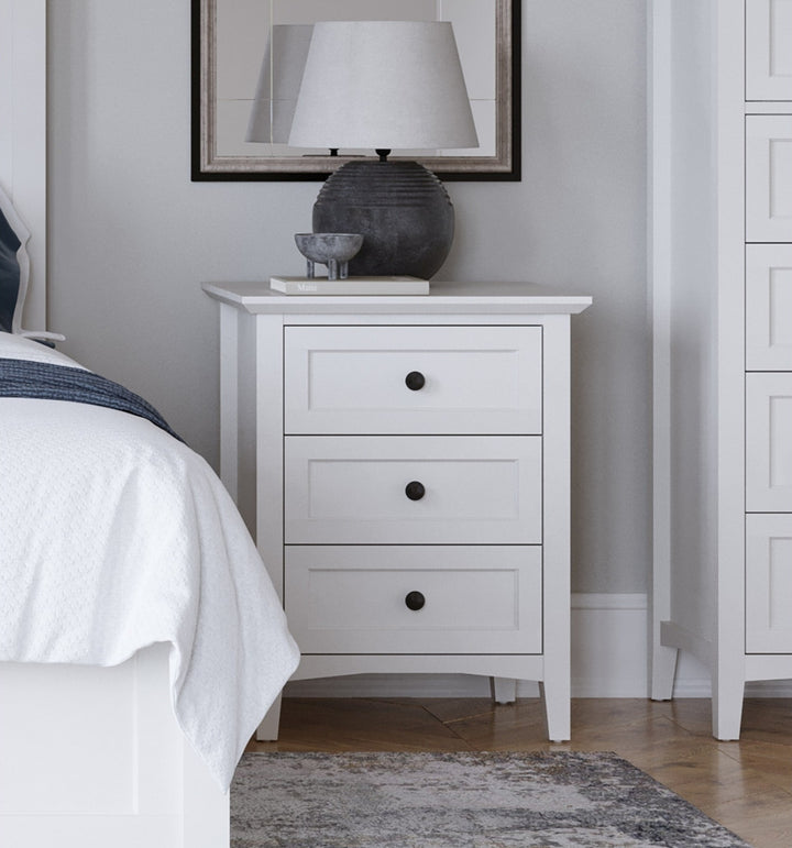 Grace Three Drawer Nightstand in Snowfall White — in a bedroom setting