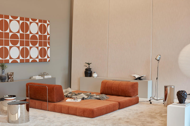 CozyPad Sleeper Sofa by Innovation Living in rust orange velvet with one back cushion raised as a lounge beneath a geometric wall print