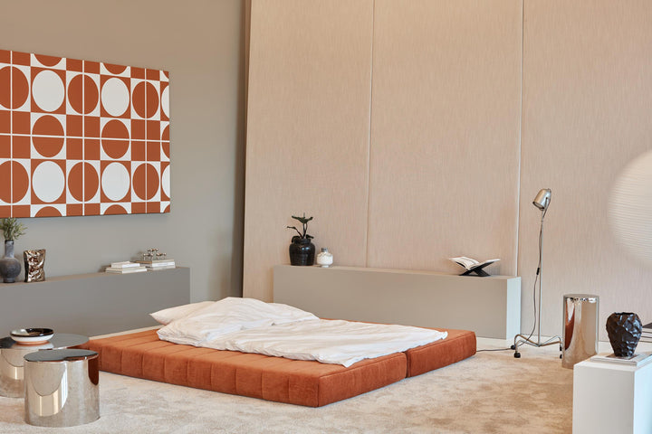 CozyPad Sleeper Sofa by Innovation Living in rust orange velvet laid out as a double bed with white bedding beside chrome side tables