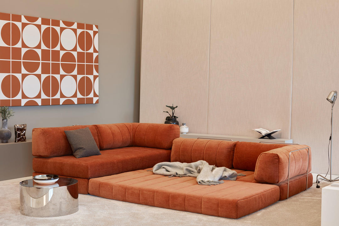 CozyPad Sleeper Sofa L-Shape with arm by Innovation Living in rust orange velvet with the chaise opened as a lounge and a grey throw