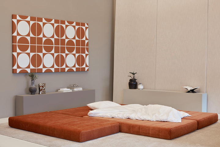 CozyPad Sleeper Sofa L-Shape with arm by Innovation Living in rust orange velvet laid flat as a large bed with white bedding
