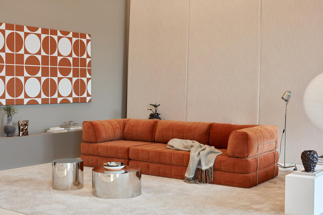 CozyPad Sleeper Sofa Grand with arms by Innovation Living in rust orange velvet as a sofa with a throw and chrome side tables