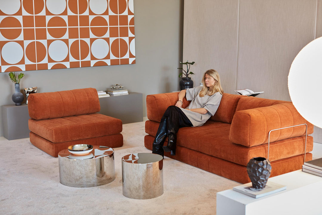 CozyPad Sleeper Sofa Grand with arms by Innovation Living in rust orange velvet split into a sofa and chair with a woman reading