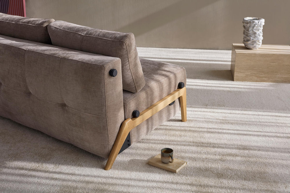 Cubed Sleeper Sofa with Wood Legs by Innovation Living seat cushion with oak wood leg detail on a grey rug